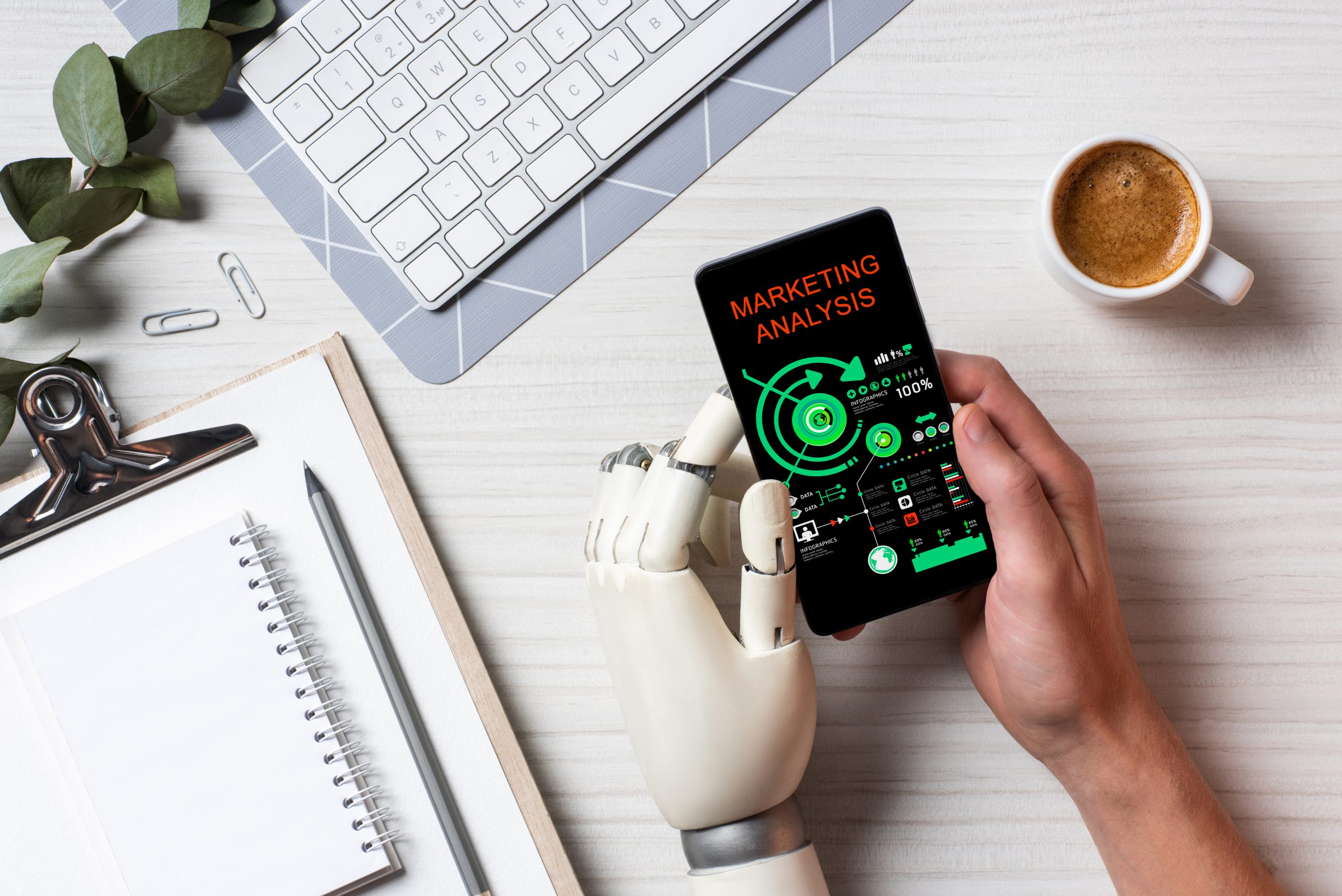 cropped image of businessman with prosthesis arm using smartphone with marketing analysis on screen